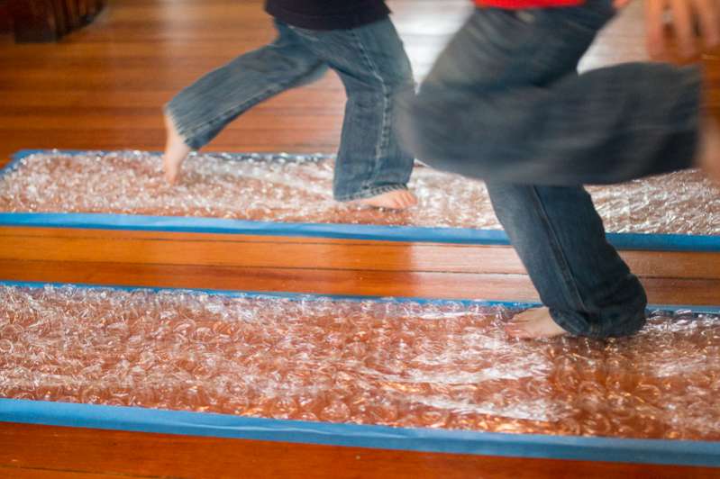 Boys running on bubble wrap